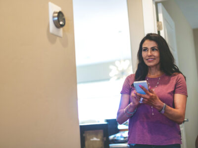 person looking at their thermostat